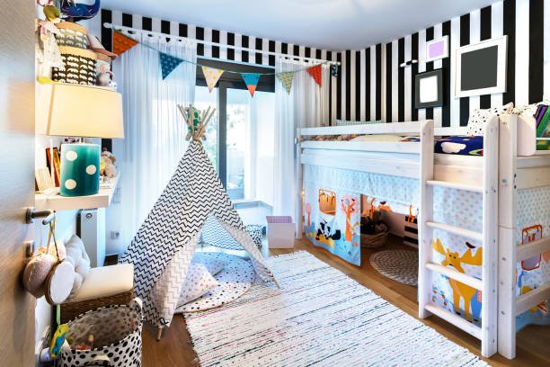 Kids bedroom  with bunk wooden bed, teepee, stands, carpet frames and toys